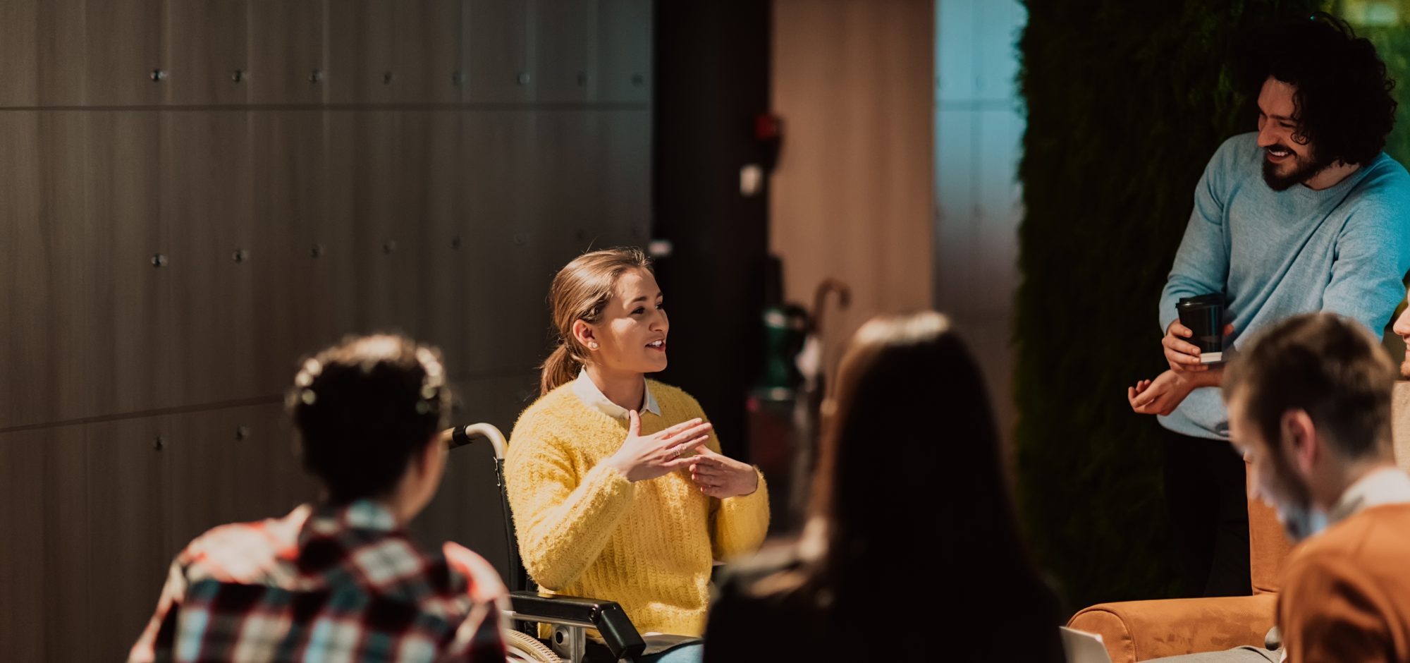 Inclusion, lady in a wheel chair talking to 4 people in a semi circle